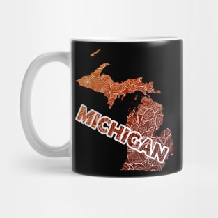 Colorful mandala art map of Michigan with text in brown and orange Mug